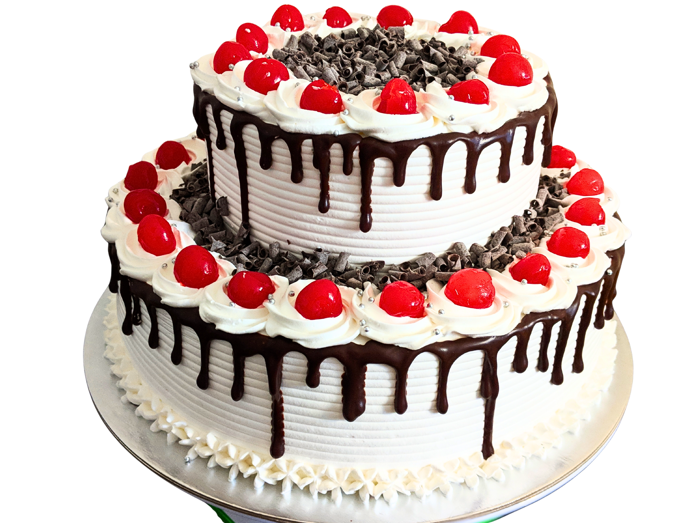 Two-tier black forest cake decorated with chocolate shavings and fresh cherries